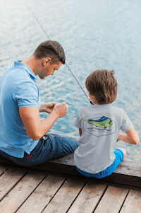 father and son fishing on a dock